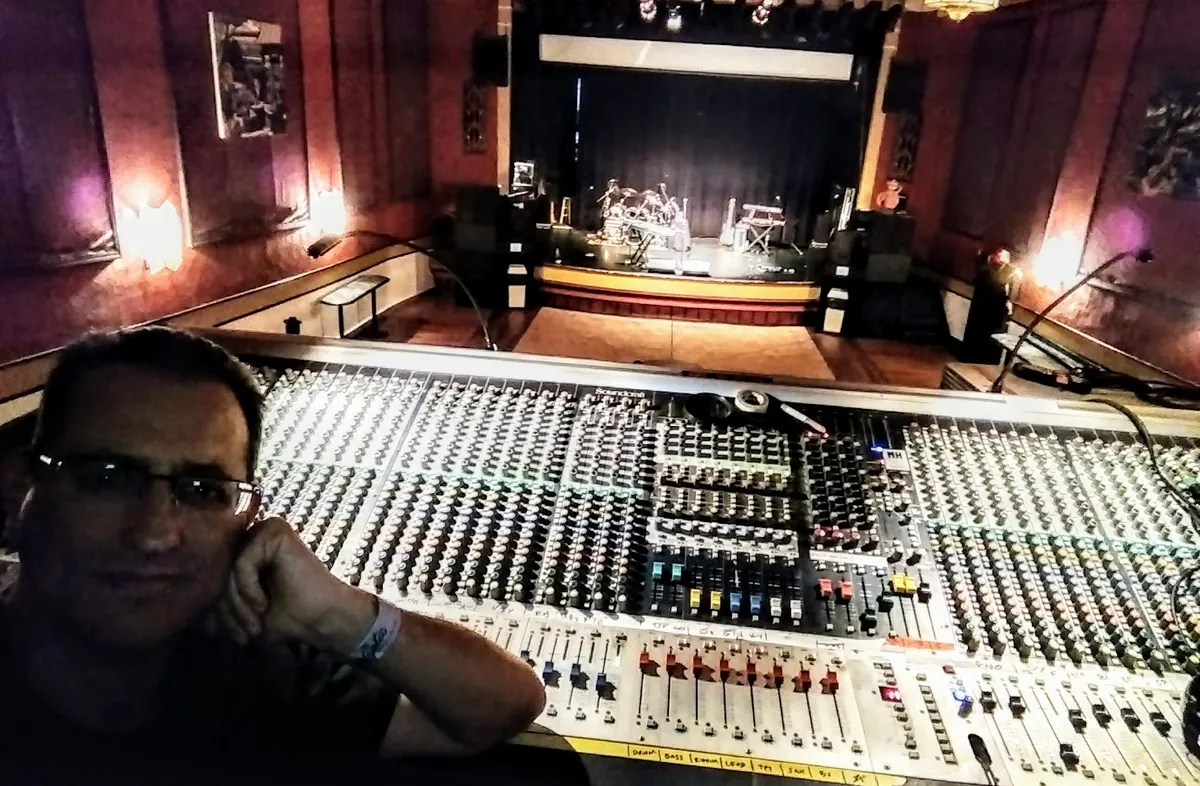 Néstor Randazzo at a Soundcraft console overlooking a theater stage